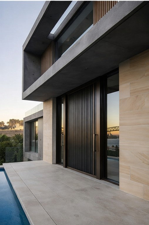 Cast aluminium pivot door exterior entrance view
