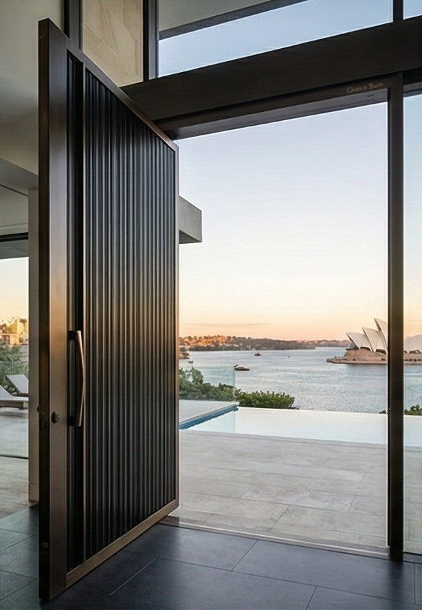 Cast aluminium pivot door opening with Sydney Harbour view
