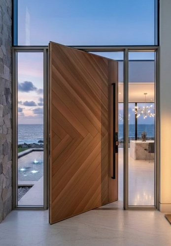 Cast aluminium pivot door with timber finish for modern Australian coastal home