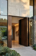 Timber-look cast aluminium pivot door with realistic wood grain finish, luxury modern home entrance