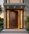 Cast aluminium pivot door at modern stone facade home entrance
